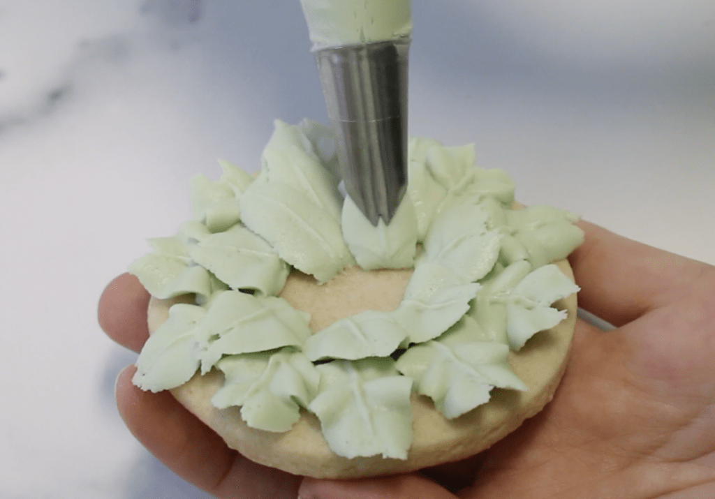 Add more layers of buttercream leaves