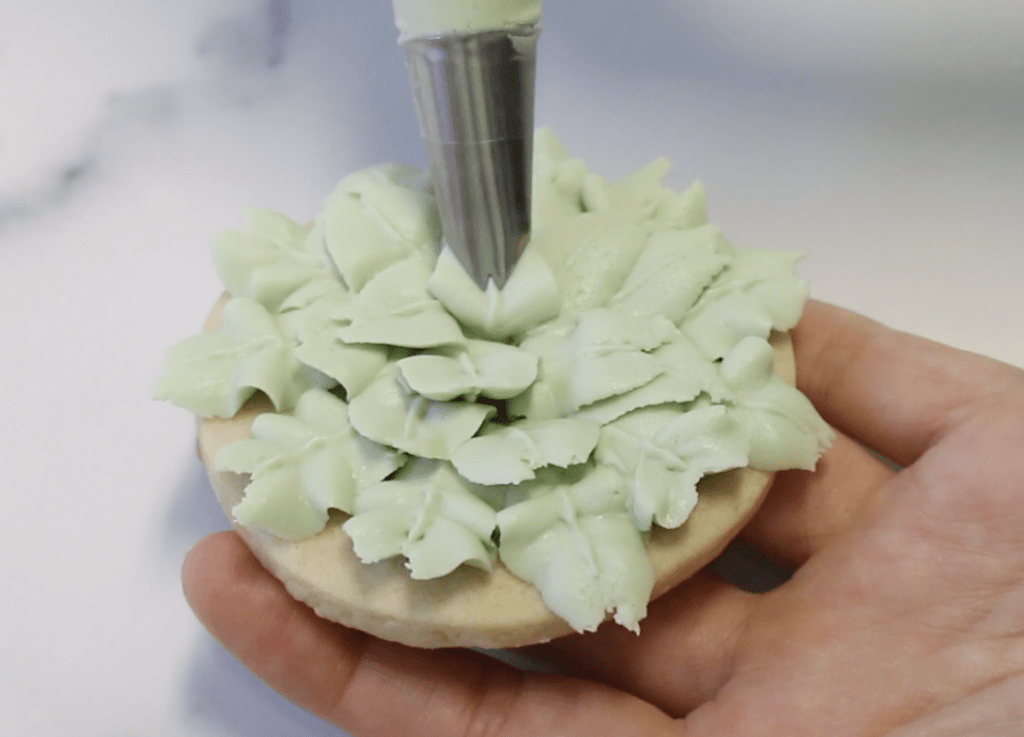 Close the center with another buttercream leaf