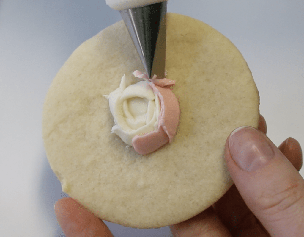 Add pink buttercream petals