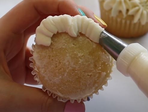 On the edge of the cupcake, move the tip back and forth to make ruffles in a "c" motion