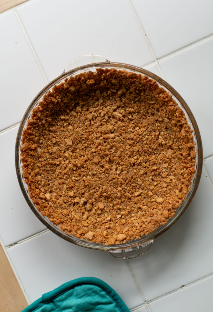 key lime pie crust in a glass pie dish